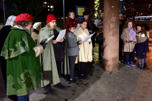 Roosevelt Island Year in Pictures, 2018: Part Two Carolers kicked off the holiday seasons, singing for riders under cover from a light rain at the subway station.